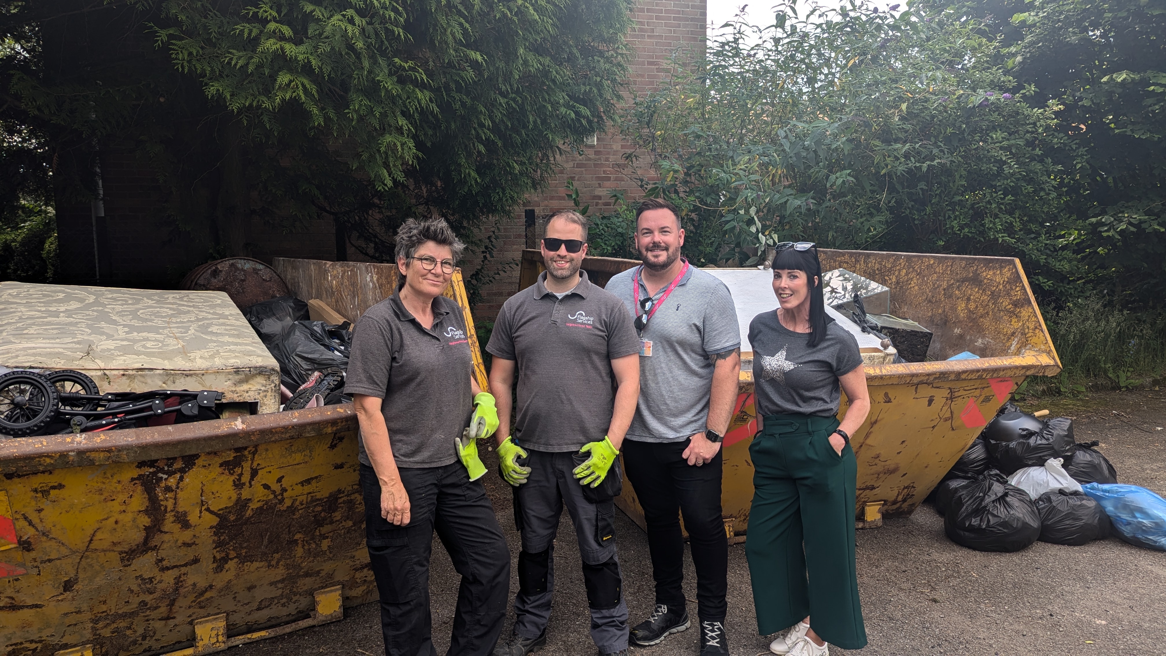 L-R Flagship Services neighbourhood officers Lisa Bielby and Mark Palmer, neighbourhood services manager Joe McNeill, and BITC’s Head of Place (Norwich) Tracey Drake pose by the skips
