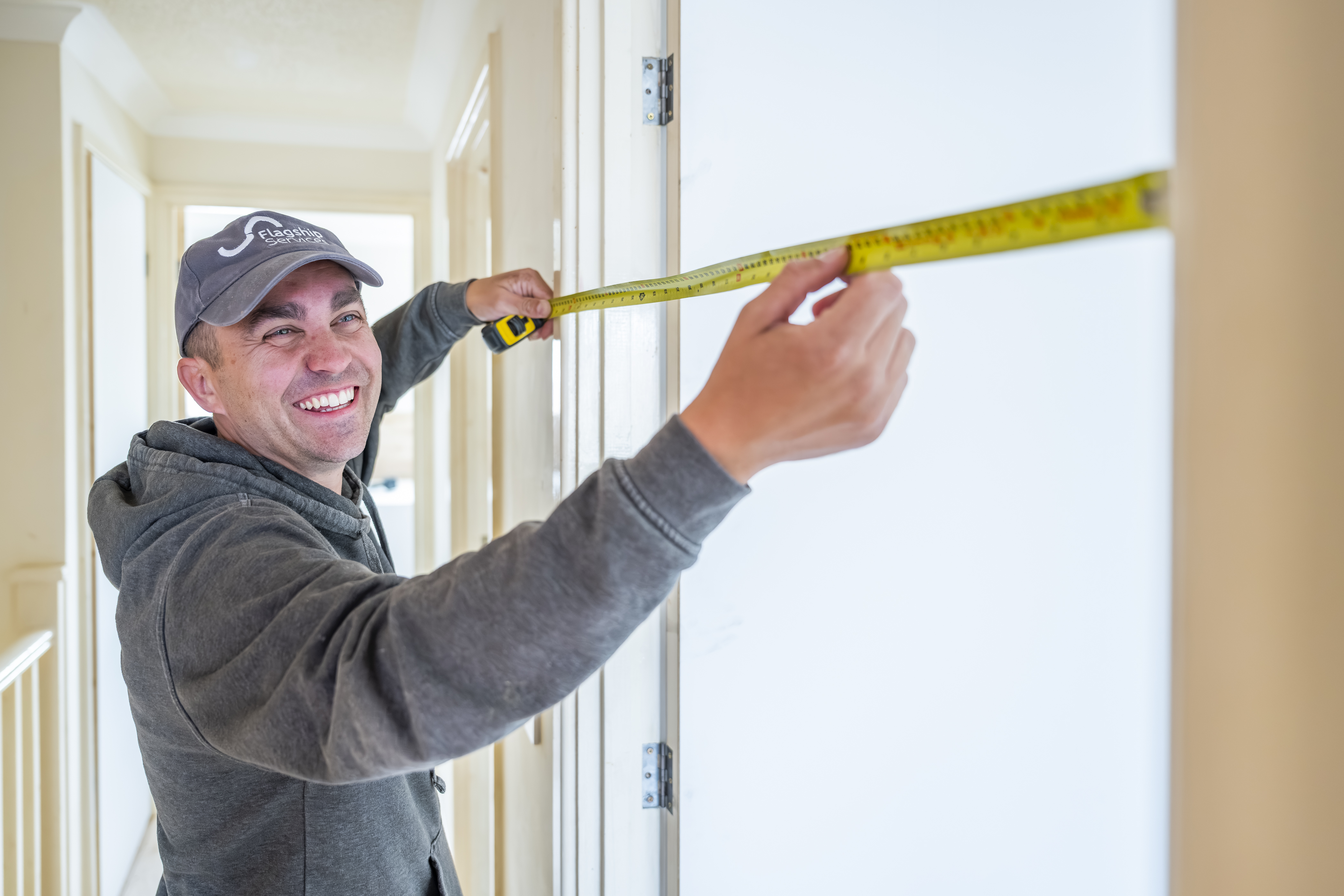 Flagship Services operative measuring a doorway