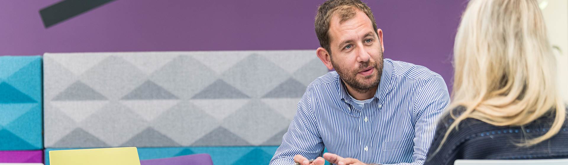 Two members of staff having a conversation