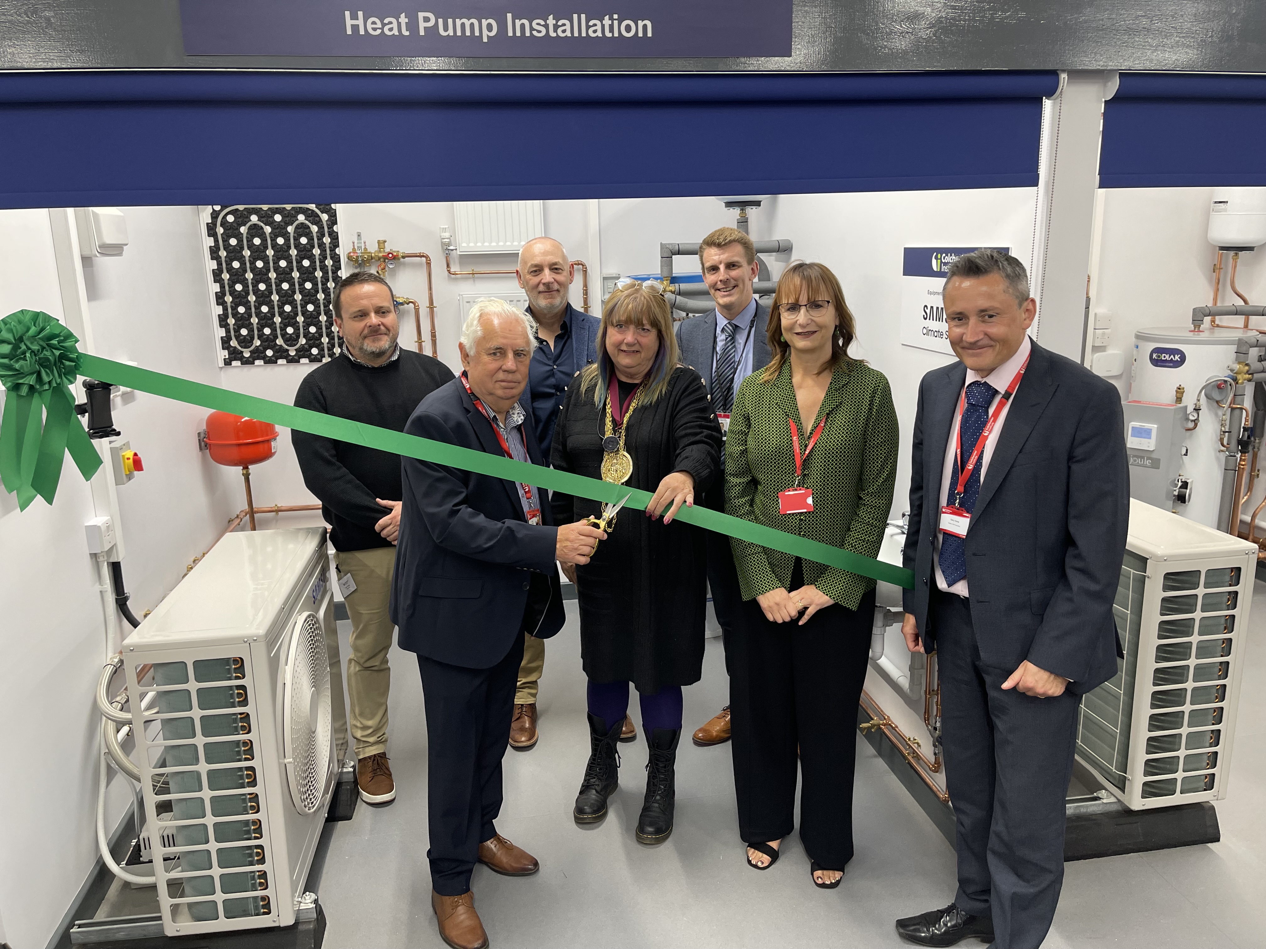 Colchester Institute’s board chair, Kevin Prince, cuts a ribbon to officially open the new Net Zero and Renewables Centre alongside representatives from the institute, Flagship, and Gasway (credit: Flagship)