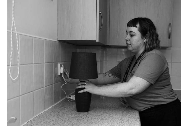 Lady putting the kettle on