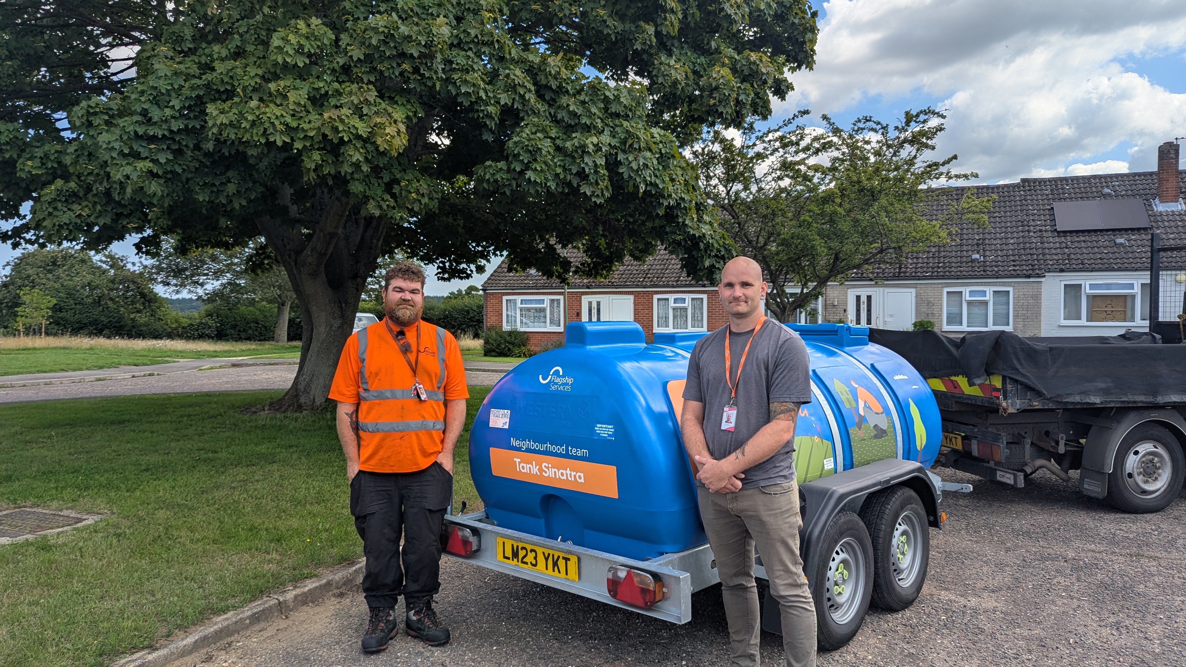Michael Waters, left, and Dan Curtis with Flagship Services water bowser Tank Sinatra