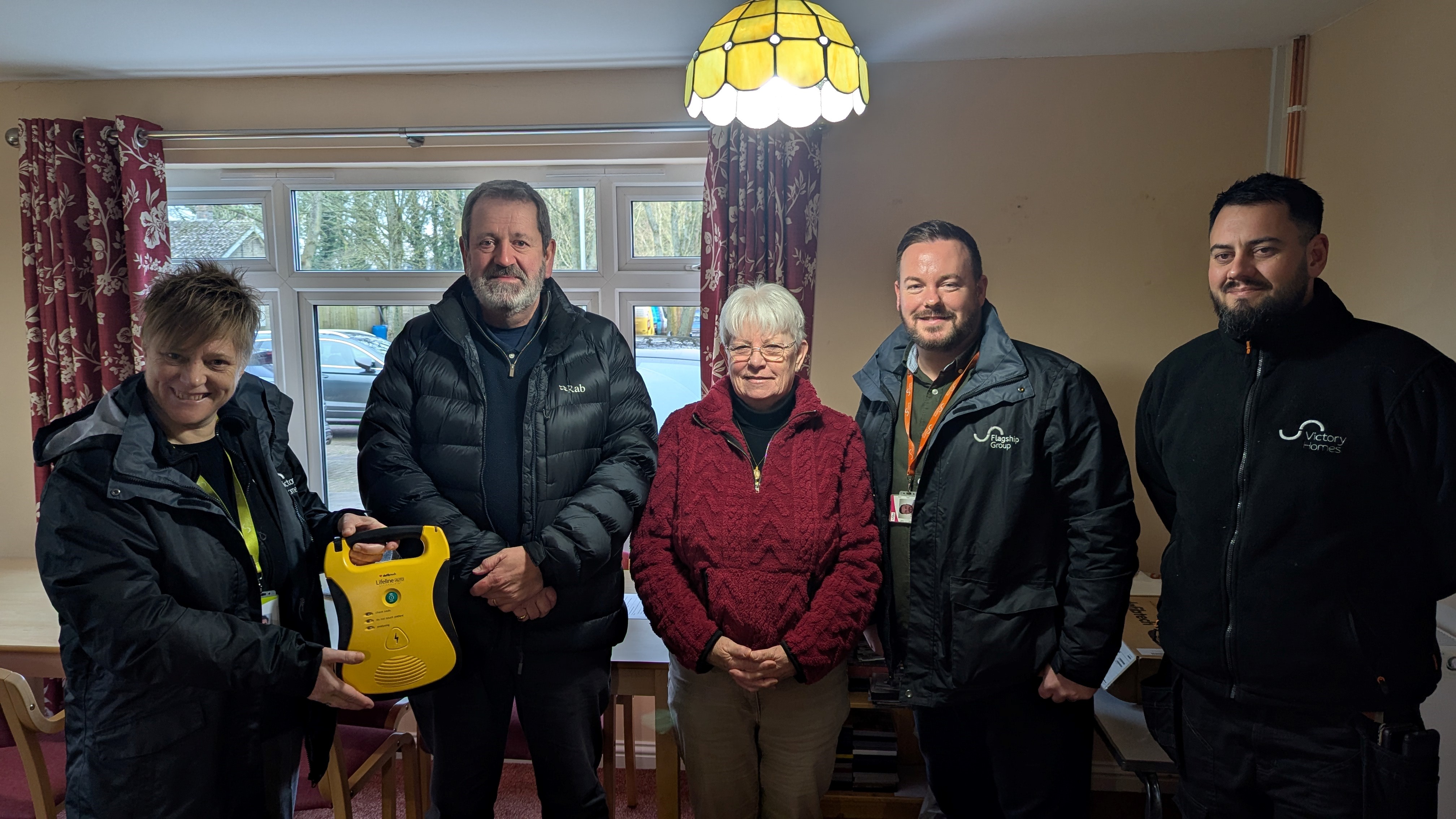 From left, Victory Homes head of housing Jay Furner gives the defibrillator to Weasenham parish council vice chair Tom McClenaghan. Also there were parish councillor Jackie Hargreaves, Flagship neighbourhood operations manager Joe McNeill and neighbourhood officer Stefon Cieschinger