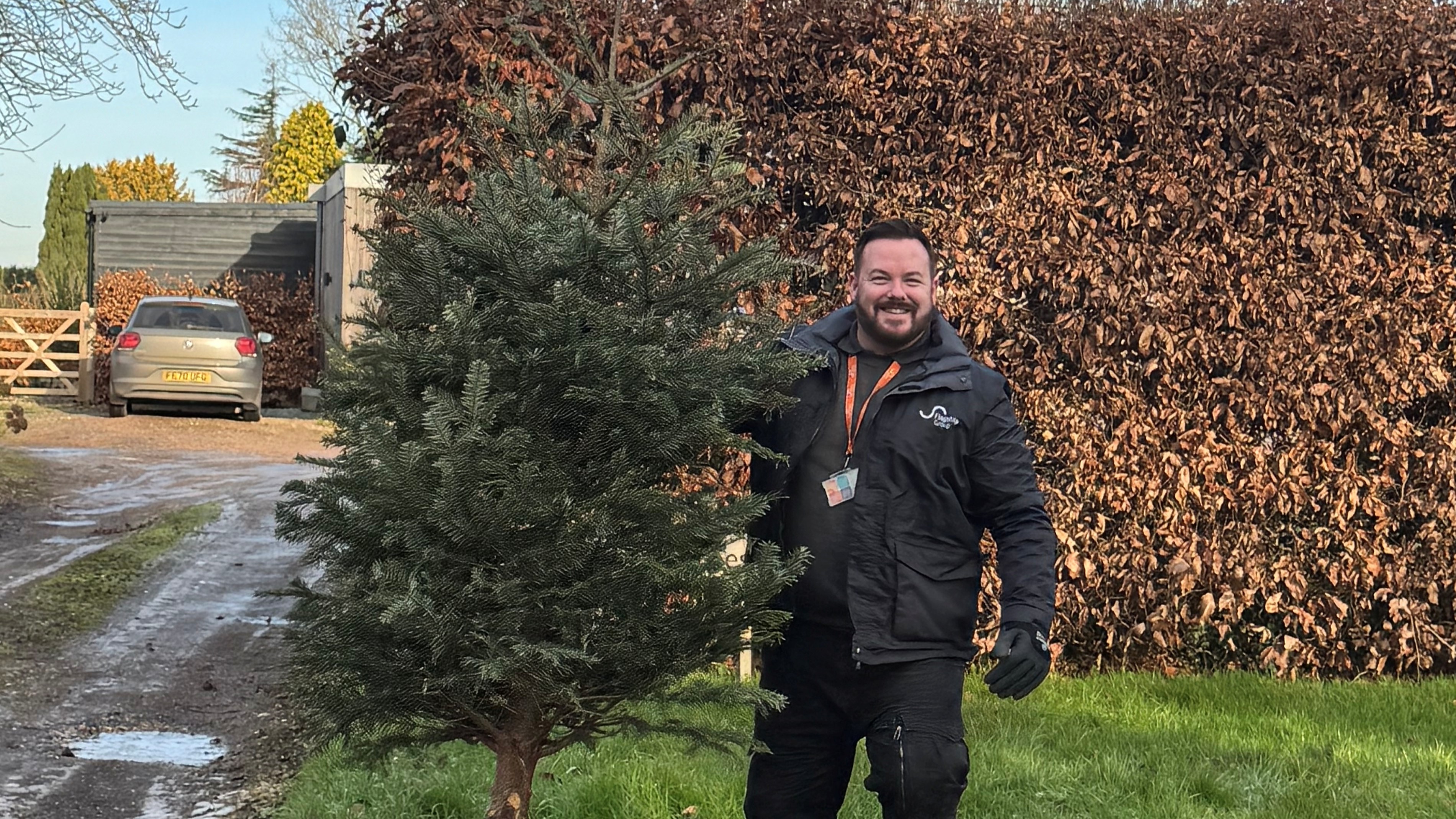 Neighbourhood operations manager Joe McNeill wrangles a Christmas tree, one of the 1,400 gathered in the Norfolk collections