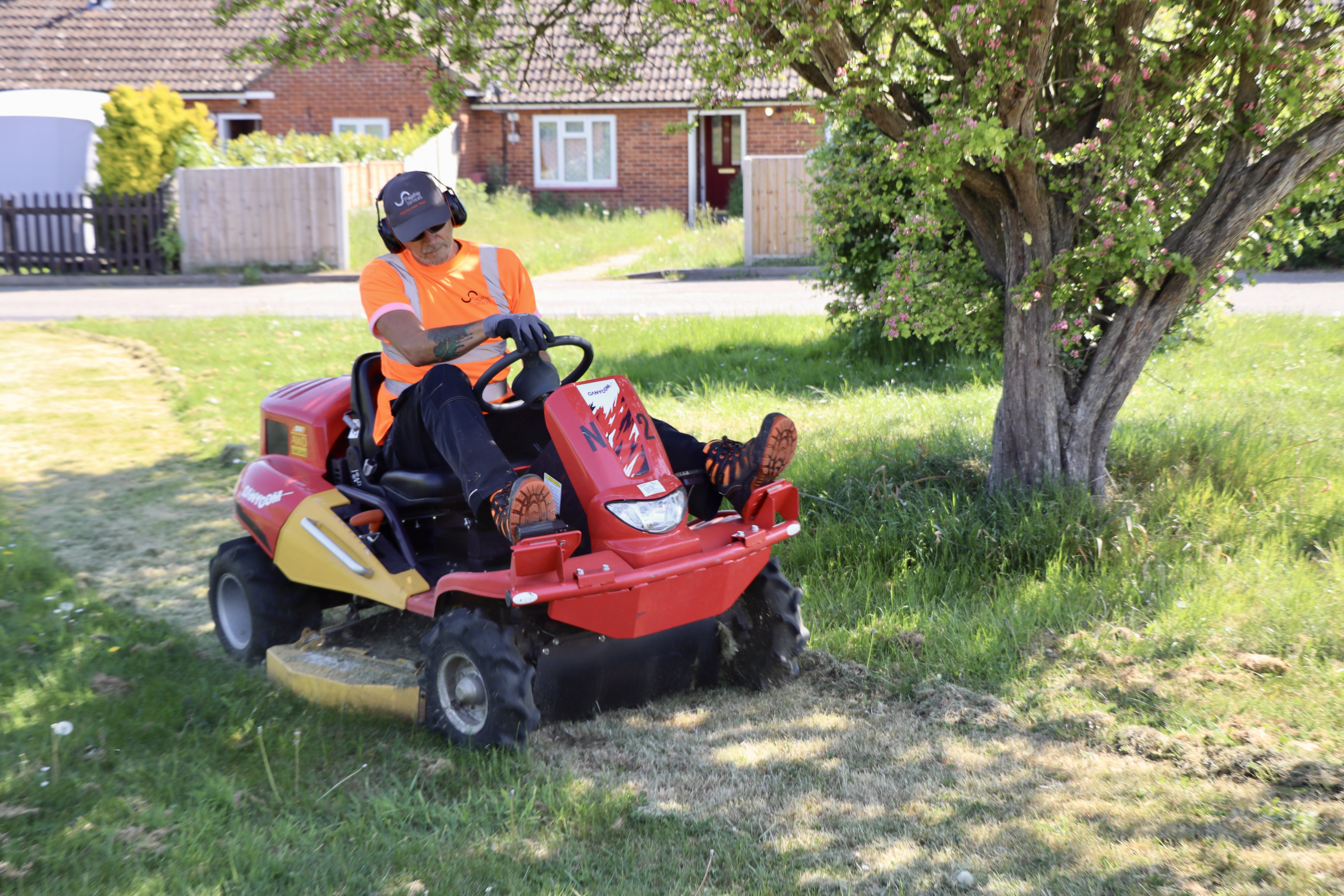 Flagship gardener Gary Baggott cuts a path through the meadow, off West View in Kelsale, Saxmundham
