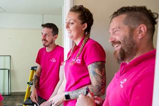 Three people wearing Flagship Services polos