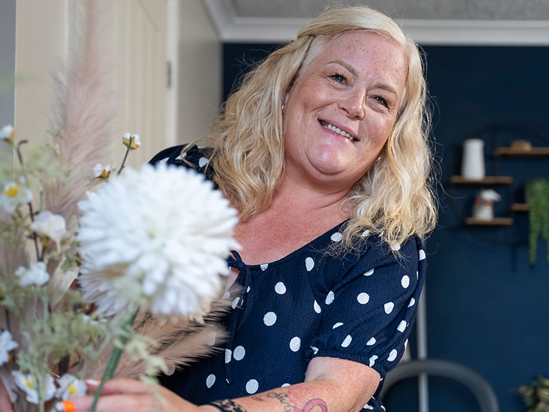 lady at home with a flower