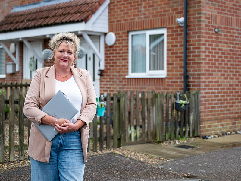 Flagship Housing team member outside a home