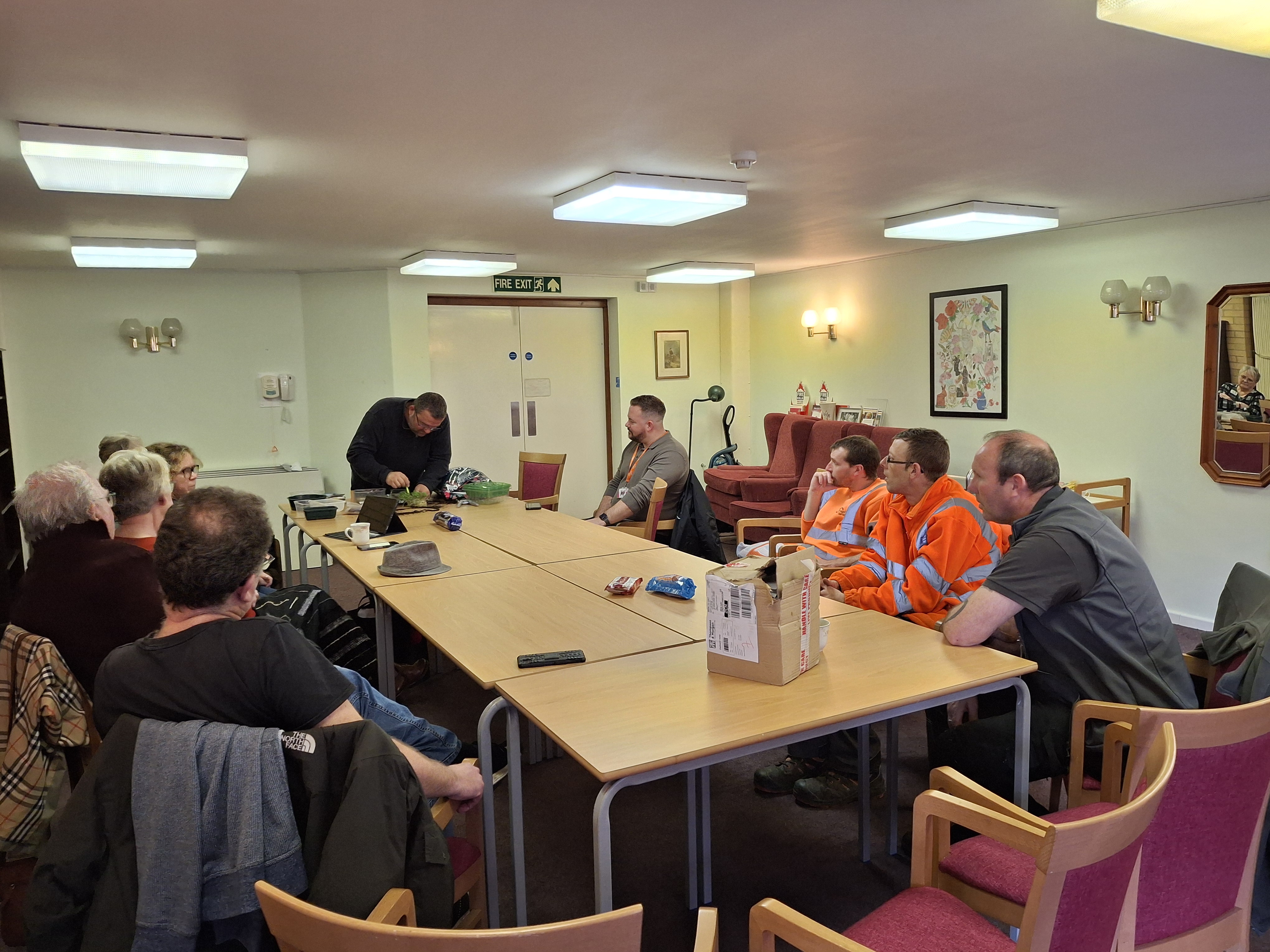 Members of the local community and Flagship’s neighbourhood team watch on as Chris Collins delivers a presentation on urban gardening