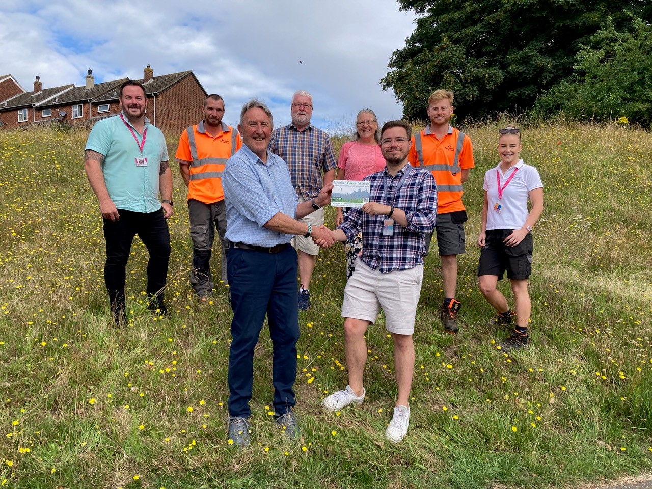 Mark Allbrook, Cromer Green Spaces chairman, presents Flagship’s biodiversity and land manager Daniel Salliss with the plaque at Meadow Close in Cromer. Back row, from left, Joe McNeill and Nick Thorp from Flagship, Chris Wright and Caroline Ashworth from Cromer Green Spaces, and Callum Taylor and Charlotte Bane from Flagship (credit: Brenda Stibbons)