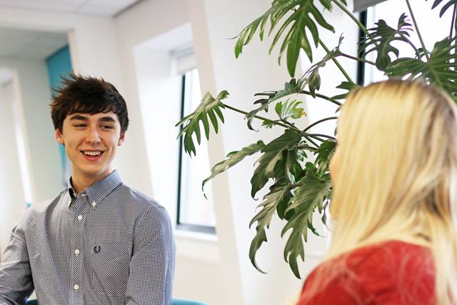 Two people chatting in an office